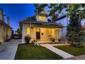 Inviting home showcasing a quaint front porch, lush green lawn, and classic design elements, ideal for a cozy atmosphere at 340 S Logan St, Denver, CO 80209