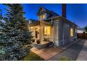 Elegant home with a covered porch, mature landscaping, and timeless architectural details, creating a welcoming facade at 340 S Logan St, Denver, CO 80209