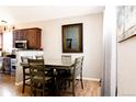 Bright dining room featuring a dining table with seating for six and wood flooring at 16952 Dandelion Way, Parker, CO 80134