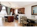 Modern kitchen with an island, stainless steel appliances, and adjacent dining area at 16952 Dandelion Way, Parker, CO 80134