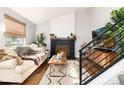 Cozy living room features a fireplace, plush sofa, and stylish decor at 4800 S Tabor St, Morrison, CO 80465