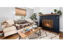 Comfortable living room showcasing a fireplace, sofa, and decorative coffee table at 4800 S Tabor St, Morrison, CO 80465