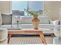 Close-up of a living room showcasing a stylish coffee table arrangement and comfortable white sofa at 9002 Birch Run Dr, Parker, CO 80134
