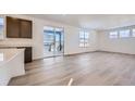 Open living room with hardwood floors and sliding glass doors to patio at 544 Twilight St, Erie, CO 80516