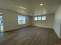 Spacious living room with hardwood floors and large windows at 544 Twilight St, Erie, CO 80516