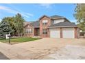 Charming two-story brick home with an attached two-car garage and a spacious driveway at 801 S 15Th Ave, Brighton, CO 80601