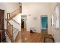 Bright foyer with hardwood floors, a staircase, and an open floor plan at 801 S 15Th Ave, Brighton, CO 80601