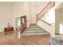Bright foyer featuring beautiful hardwood floors, stairs to the second floor, and high ceilings at 801 S 15Th Ave, Brighton, CO 80601