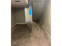 View of the basement with carpet flooring and a partially visible window, showing the layout of the space at 1222 Yosemite St, Denver, CO 80220
