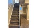 Carpeted stairs with black railing, providing access to the basement, with a glimpse of basement space at 1222 Yosemite St, Denver, CO 80220