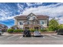 Charming condominium building with stone accents, manicured landscaping, and convenient parking at 12711 Colorado Blvd # 714G, Thornton, CO 80241