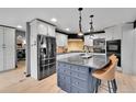 Modern kitchen featuring granite countertops, stainless steel appliances, and a breakfast bar at 1 Red Fox Ln, Littleton, CO 80127