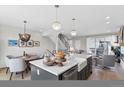 Open floor plan with stylish kitchen island, dining area, and comfortable seating offers a modern living space at 8028 W 52Nd Ln # B, Arvada, CO 80002
