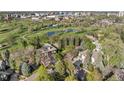 Desirable neighborhood aerial view with mature trees, green spaces, and city views in the distance at 1991 E Alameda Ave # 14, Denver, CO 80209