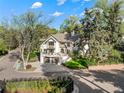 Imposing two-story white home with mature landscaping and a two-car garage in a quiet neighborhood at 1991 E Alameda Ave # 14, Denver, CO 80209