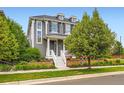 Beautiful two-story home featuring manicured landscaping and classic architectural details at 3597 Xanthia St, Denver, CO 80238