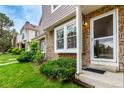 Charming townhome displaying a mix of stone and vinyl siding, complemented by a lush green lawn at 4636 S Dillon Ct # B, Aurora, CO 80015
