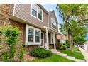Townhouse with stone accents and siding, showcasing a neat lawn and inviting walkway at 4636 S Dillon Ct # B, Aurora, CO 80015