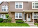 Townhouse with stone and vinyl exterior, pristine lawn, and a welcoming front entrance at 4636 S Dillon Ct # B, Aurora, CO 80015