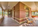Cozy wraparound porch featuring wood flooring, ample seating, and views of the surrounding yard at 835 Niagara St, Denver, CO 80220