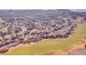 An aerial view of a single-Gathering home located near a well-maintained golf course and green space at 1339 Bent Grass Cir, Castle Rock, CO 80109