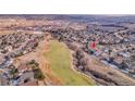 An aerial view of a single-Gathering home in a green residential area, highlighting its location near a golf course at 1339 Bent Grass Cir, Castle Rock, CO 80109