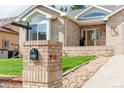 Close up of a well-maintained yard featuring a mailbox on a brick column with lush green grass at 1809 Little Bear Ct, Longmont, CO 80504