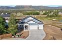 Aerial view of a lovely single-Gathering home with a three-car garage and mountain views at 17220 Snowwood Dr, Monument, CO 80132