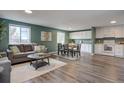 Open-concept living room and kitchen area with hardwood floors, natural light, and a cozy atmosphere at 9416 Lamar St, Westminster, CO 80031