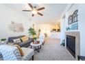 Inviting living room with a ceiling fan, fireplace and an open layout to the kitchen at 3100 Blue Sky Cir # 205, Erie, CO 80516
