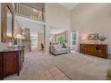 Bright living room featuring high ceilings, an open layout, neutral colors, and lots of natural light at 3860 Mallard Dr, Highlands Ranch, CO 80126