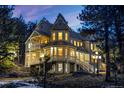 Elegant home with multiple balconies, bay windows, and meticulous architectural craftsmanship at 6857 Timbers Drive, Evergreen, CO 80439