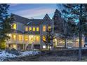 Beautiful home with a three-car garage, inviting porch, and well-maintained landscaping at 6857 Timbers Drive, Evergreen, CO 80439