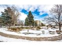 Community features a pond and trees, partially covered in snow at 13890 E Marina Dr # 107, Aurora, CO 80014