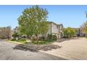 A serene view of well-maintained townhomes with manicured lawns and tree-lined streets at 3262 E 103Rd Dr # 1810, Thornton, CO 80229