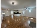 Spacious living room with hardwood floors, modern lighting, and an open concept design flowing into the kitchen at 3440 W 33Rd Ave, Denver, CO 80211