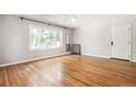 Bright bedroom with hardwood floors, updated windows, and entry door at 1416 N Downing St # 1, Denver, CO 80218