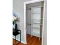 A closet with shelving and hanging rods providing efficient storage at 1416 N Downing St # 1, Denver, CO 80218