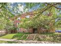 Charming brick apartment building with mature trees and landscaping at 1416 N Downing St # 1, Denver, CO 80218