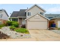 Charming two-story home with manicured landscaping, a two-car garage, and a well-maintained lawn at 4127 S Lewiston Cir, Aurora, CO 80013