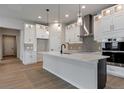 Modern kitchen featuring white cabinets, a center island, and stainless steel appliances at 461 Muirfield Cir, Louisville, CO 80027