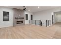 Bright living room with a sleek fireplace and staircase access at 461 Muirfield Cir, Louisville, CO 80027
