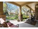 Inviting front porch with stone pillars and comfortable seating area with great curb appeal at 2042 S Clayton St, Denver, CO 80210