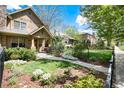 Beautifully landscaped front yard with a sidewalk leading to the entrance of the home at 2042 S Clayton St, Denver, CO 80210