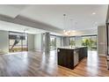 Sunlit living room boasts an open concept, hardwood floors, and large windows with views of lush surroundings at 4200 W 17Th Ave # 235, Denver, CO 80204