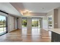 Open-concept living area with natural light, hardwood floors, and concrete pillar; seamlessly blends modern living at 4200 W 17Th Ave # 235, Denver, CO 80204