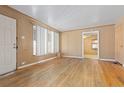 Spacious living room featuring hardwood floors, a large window, and neutral wall colors at 256 King St, Denver, CO 80219