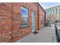 Brick exterior with front door access and a concrete walkway to the building at 1111 Osage St # 29, Denver, CO 80204