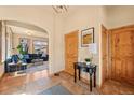 Bright foyer leading to a cozy living room, featuring tile floors, wood trim, and a welcoming atmosphere at 2673 S Cook St, Denver, CO 80210