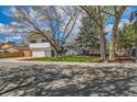 Attractive two-story home featuring mature landscaping, a lawn, and an attached two car garage at 717 S Carr Ave, Lafayette, CO 80026